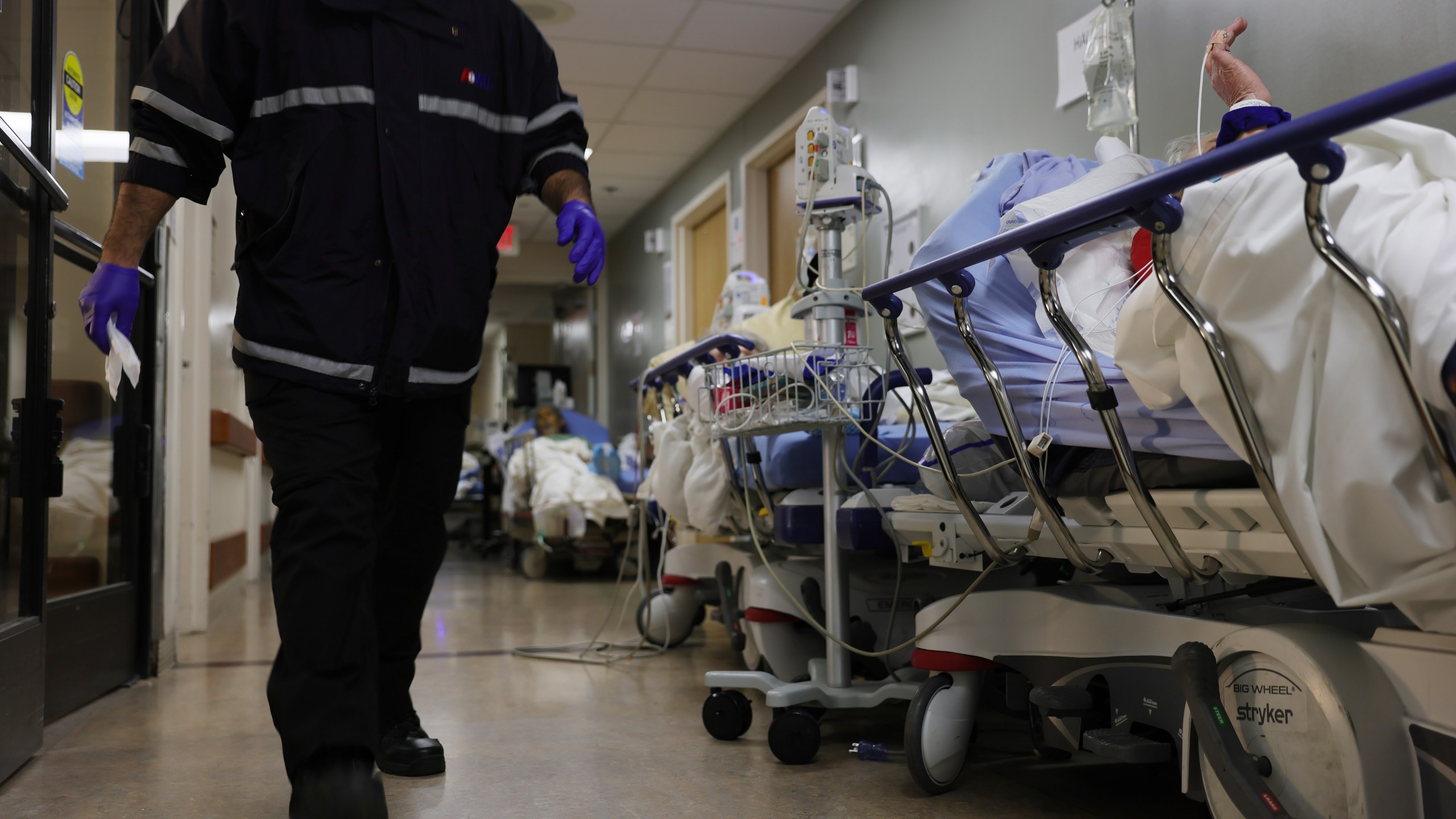 A patient lies on a stretcher in a hallway near other patients in the overloaded emergency room at Providence St. Mary Medical Center in Apple Valley on Jan. 5, 2021. (Mario Tama / Getty Images)