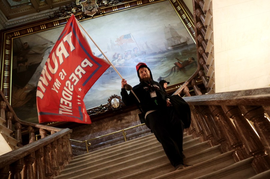 A protester holds a Trump flag inside the US Capitol Building near the Senate Chamber on January 06, 2021 in Washington, DC. (Win McNamee/Getty Images)