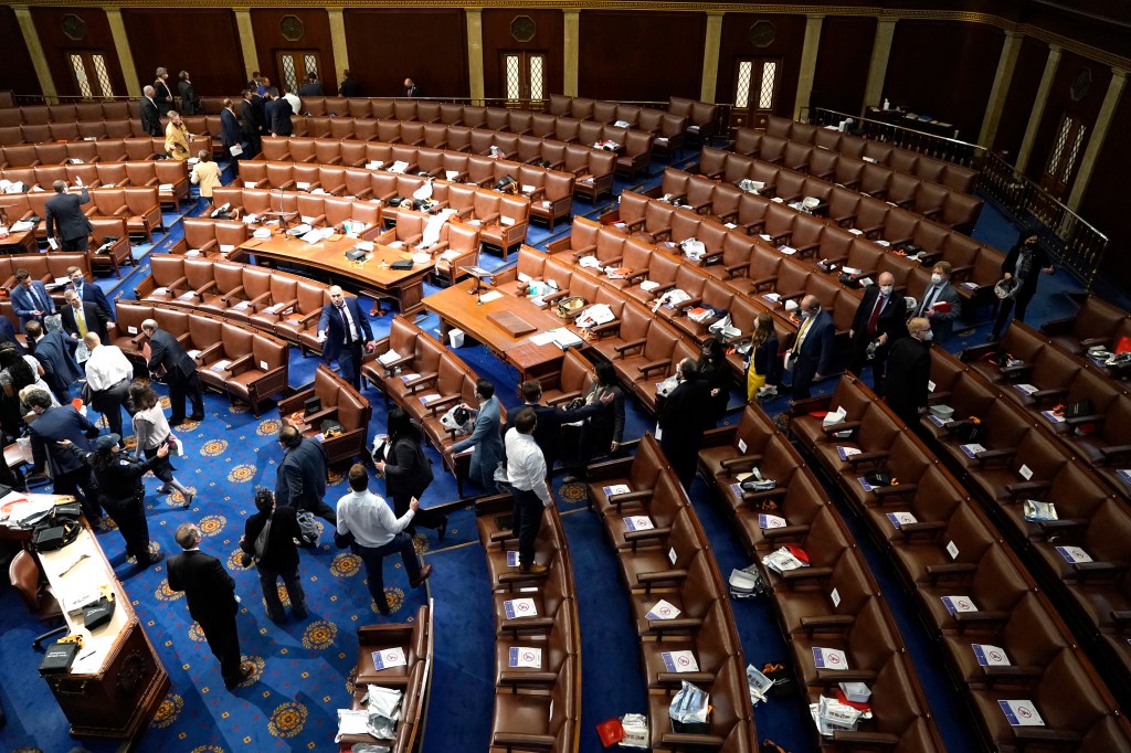 Members of Congress evacuate the House Chamber as protesters attempt to enter during a joint session of Congress on January 06, 2021 in Washington, DC. (Drew Angerer/Getty Images)