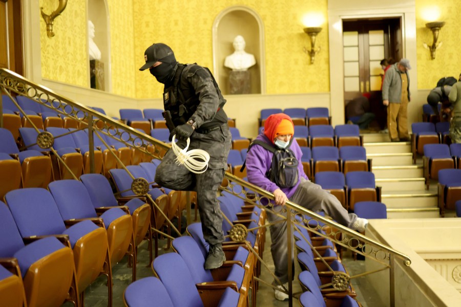 Attackers enter the Senate chamber on Jan. 6, 2021 in Washington, D.C. At least two held plastic zip-tie handcuffs. (Win McNamee/Getty Images)