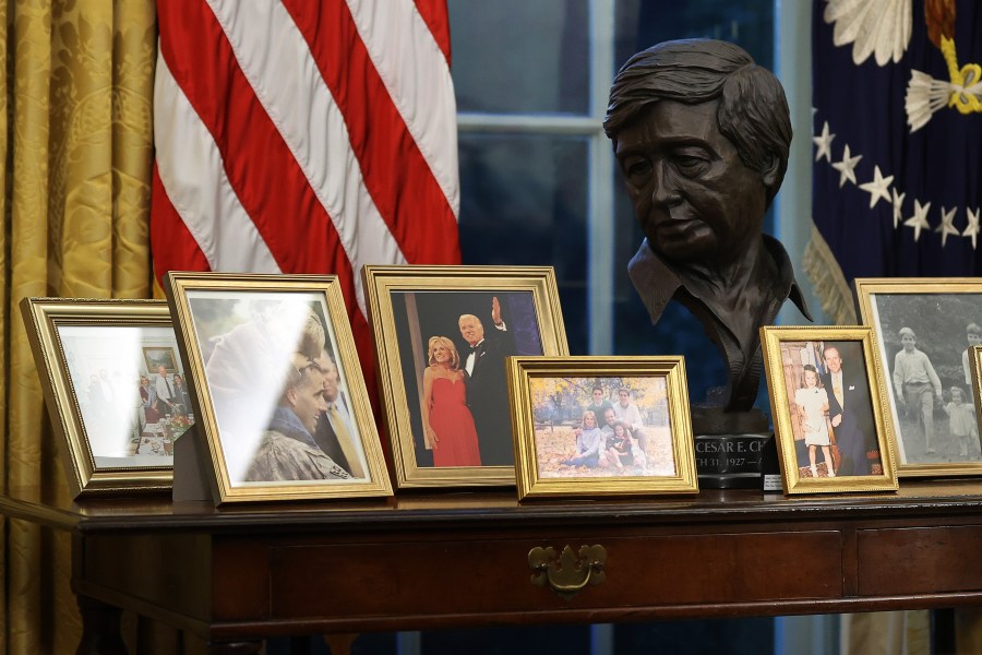 A bust of Cesar Chavez is displayed as President Joe Biden prepares to sign a series of executive orders at the Resolute Desk in the Oval Office just hours after his inauguration on Jan. 20, 2021. (Chip Somodevilla / Getty Images)