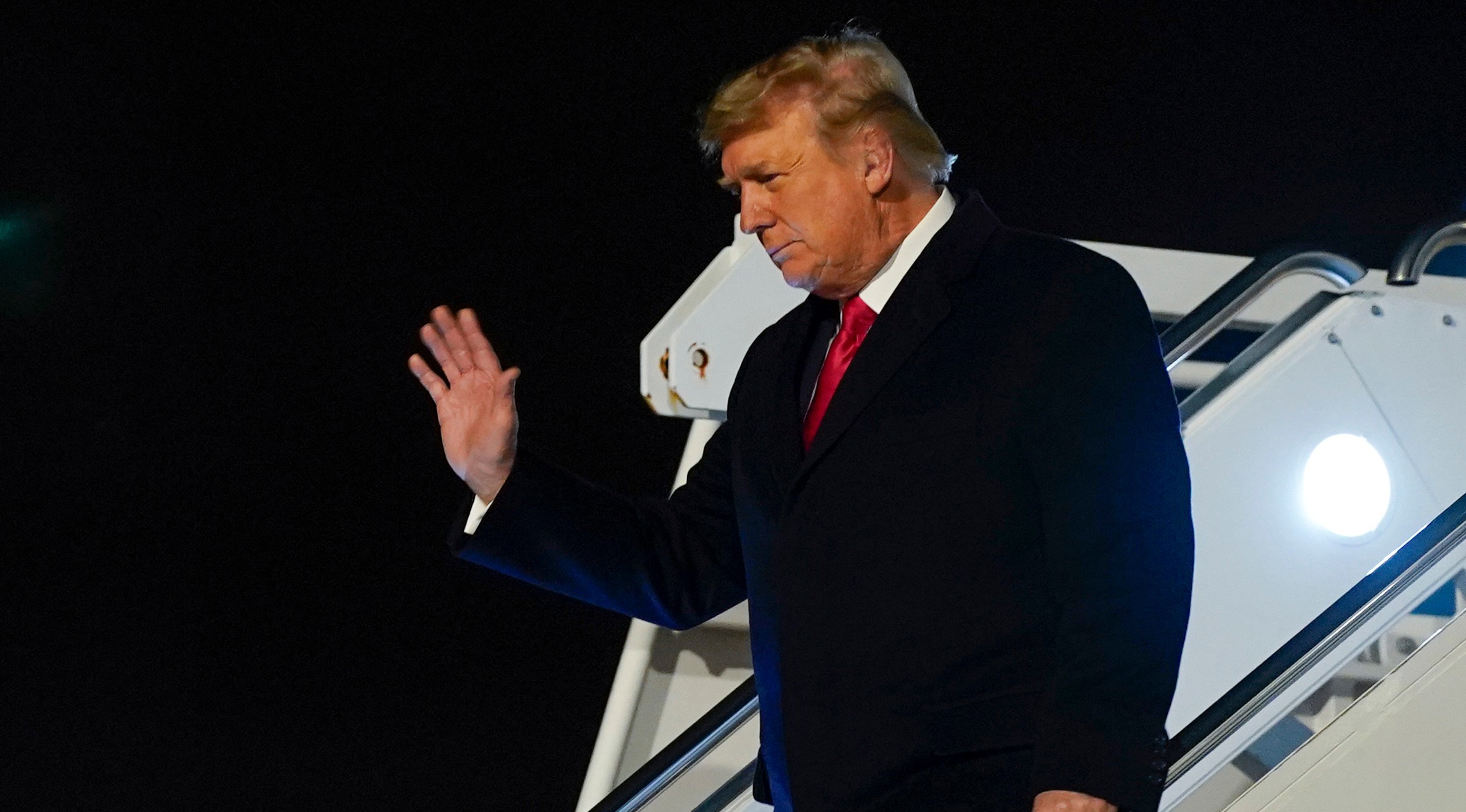 President Donald Trump arrives at Dobbins Air Reserve Base in Marietta, Ga., before heading to speak at a campaign rally for Sen. Kelly Loeffler, R-Ga., and Sen. David Perdue, R-Ga., at Dalton Regional Airport, Monday, Jan. 4, 2021, in Dalton, Ga. (AP Photo/Evan Vucci)