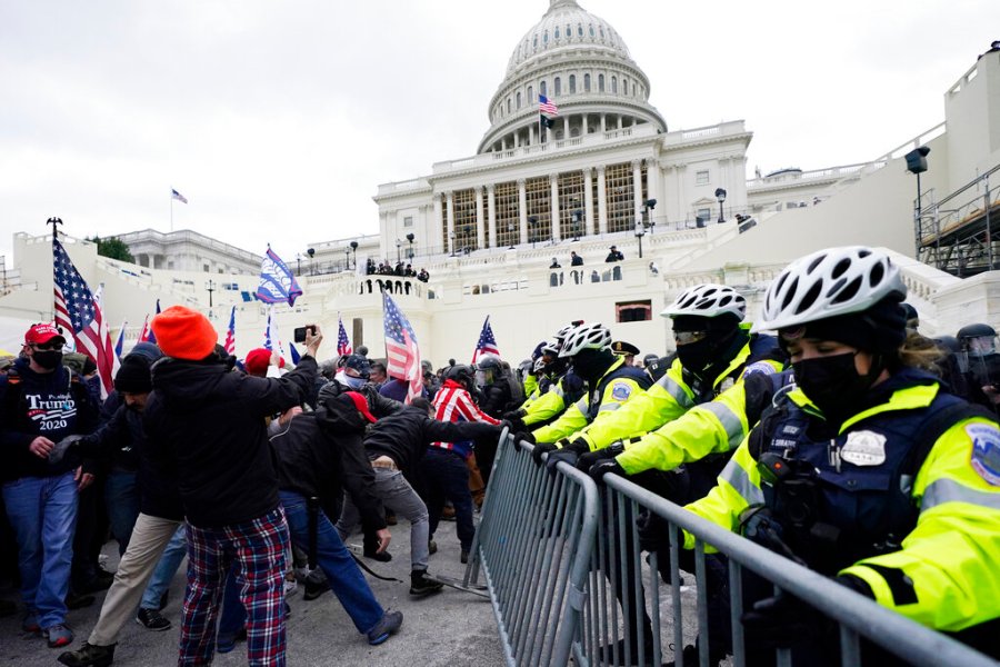 Trump supporters try to break through a police barrier, Wednesday, Jan. 6, 2021, at the Capitol in Washington. (AP Photo/Julio Cortez)