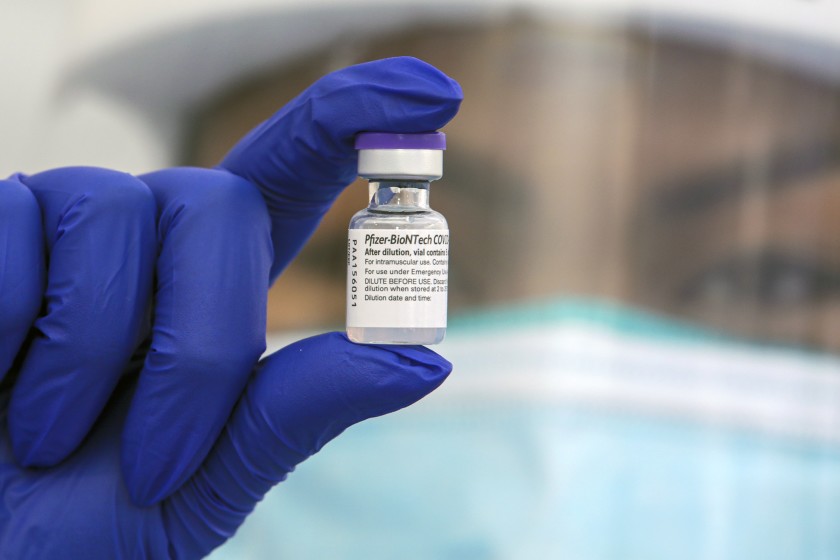 Cherry Costales, a nurse, holds a vile of Pfizer-BioNTech COVID-19 vaccine at St. John’s Well Child & Family Center.(Irfan Khan / Los Angeles Times)