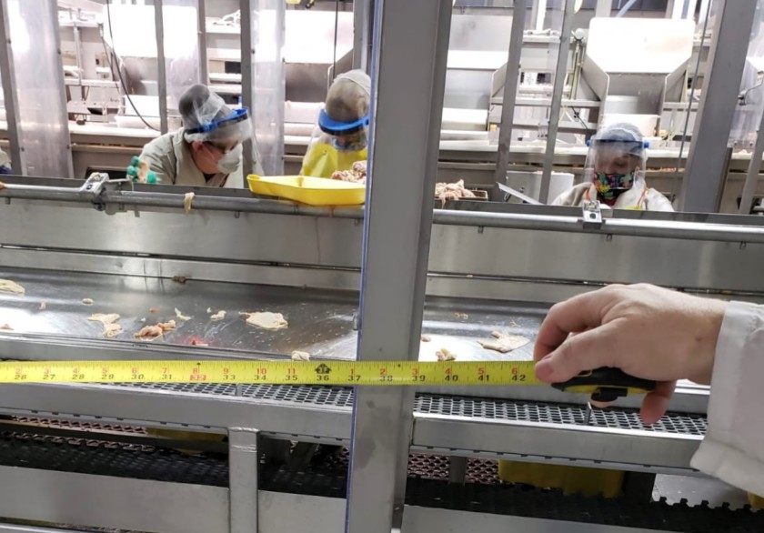 Plexiglass dividers at a meatpacking factory in Livingston, Calif., give workers a little more than three feet of space, according to this photo, which is included in a United Farm Workers lawsuit against Foster Farms. (Oscar Mejia / United Farm Workers)