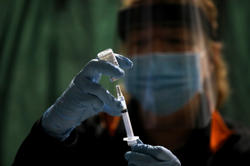 Registered nurse Ruth Ann Rowan prepares a syringe with Moderna’s COVID-19 vaccine at the Corning Volunteer Fire Department in rural Tehama County.(Gary Coronado / Los Angeles Times)