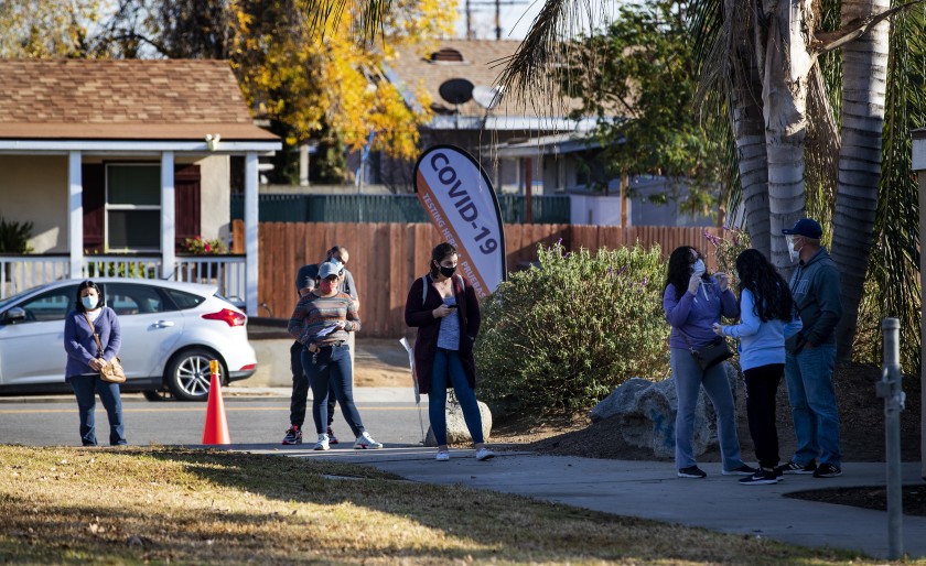 Riverside County residents wait in line for walk-up COVID-19 testing at a neighborhood park on Jan. 5 in Riverside.(Gina Ferazzi / Los Angeles Times)