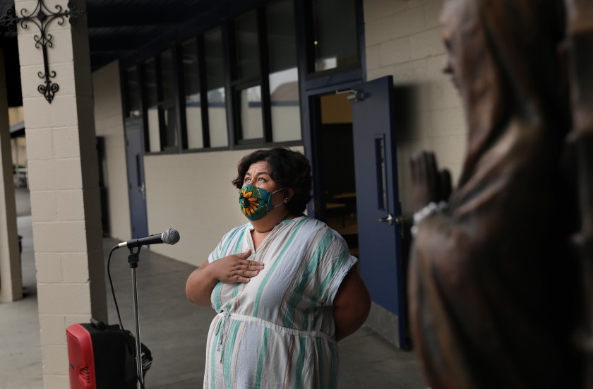 St. Joseph Catholic Elementary School in La Puente saw its attendance drop dramatically in the fall. Above, second-grade teacher Marisela Sahagun leads the Pledge of Allegiance.(Christina House / Los Angeles Times)