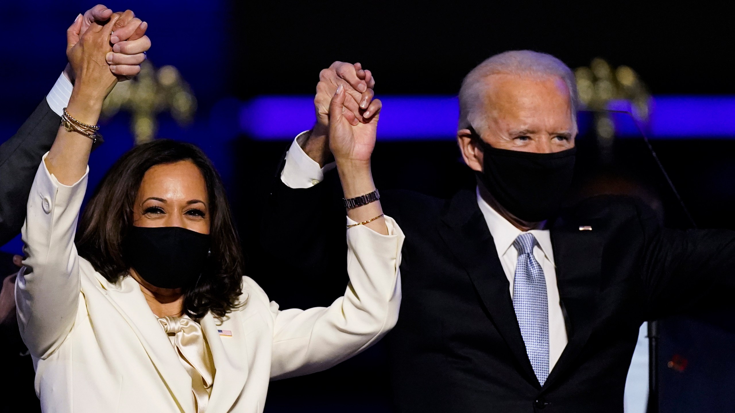 Vice President-elect Kamala Harris holds hands with President-elect Joe Biden and her husband Doug Emhoff as they celebrate Saturday, Nov. 7, 2020, in Wilmington, Del. (AP Photo/Andrew Harnik)