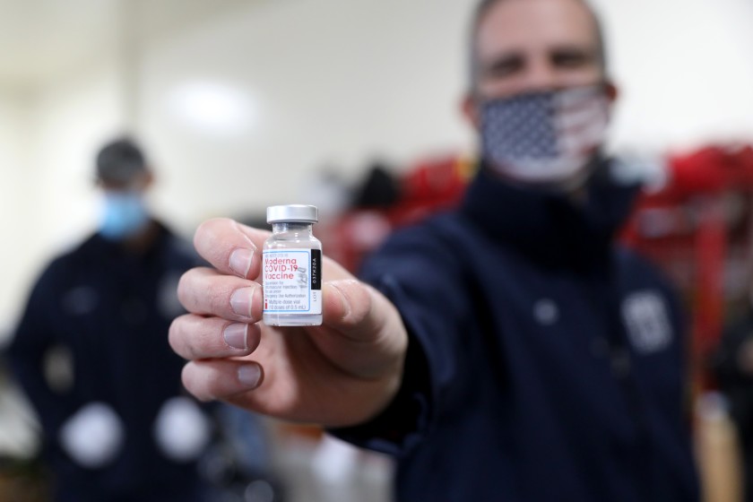 Los Angeles Mayor Eric Garcetti holds the Moderna COVID-19 vaccine at the rollout of shots for the city Fire Department in this undated photo. (Gary Coronado/Los Angeles Times)