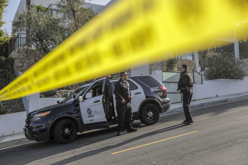 LAPD officers closed the road leading to a scene in the Hollywood Hills where Pop Smoke, a rising New York rapper, was fatally shot Feb. 19, 2020. (Irfan Khan / Los Angeles Times)