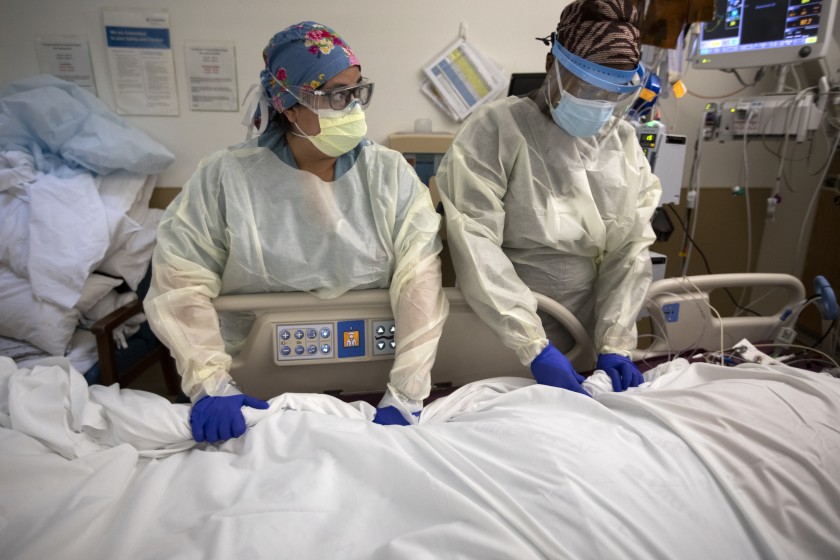 Health care workers at Providence Holy Cross Medical Center in Mission Hills on Dec. 29, 2020 struggle to keep up with the number of COVID-19 patients in the hospital’s intensive care unit. (Francine Orr/Los Angeles Times)