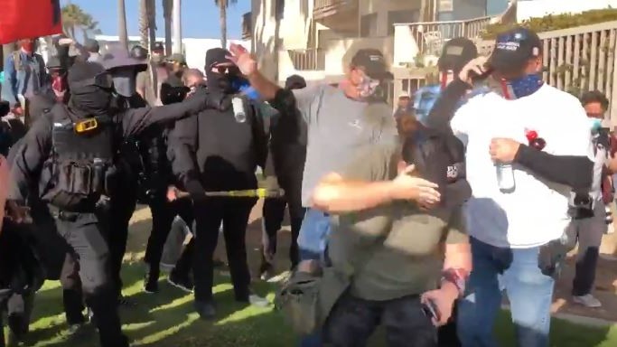 One person sprays chemicals at Trump supporters after a rally in Pacific Beach turned violent on Jan. 9, 2021. (Paul Makarushka via KSWB)