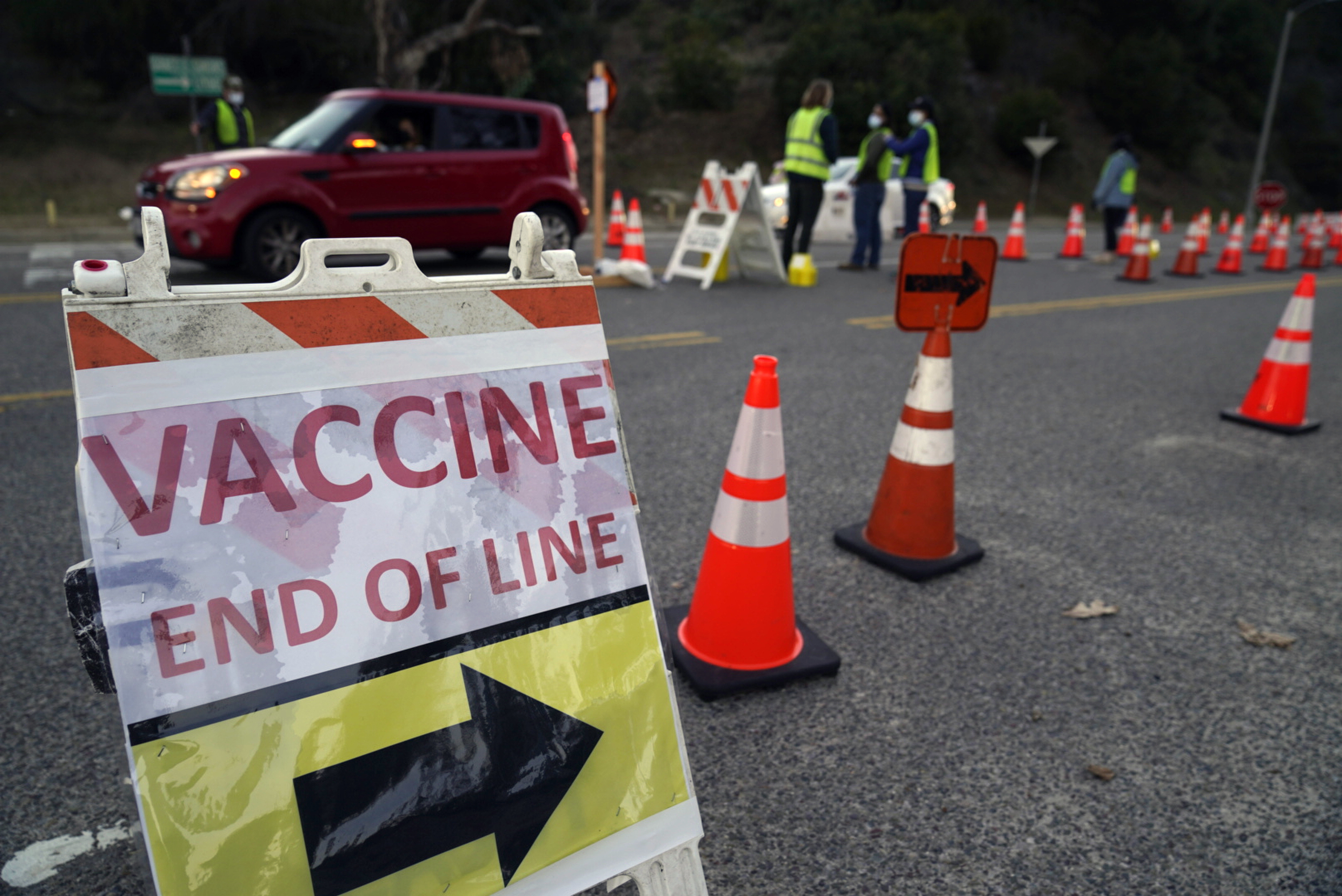 Drivers with a vaccine appointment enter a mega COVID-19 vaccination site set up in the parking lot of Dodger Stadium in Los Angeles Saturday, Jan. 30, 2021. (AP Photo/Damian Dovarganes)