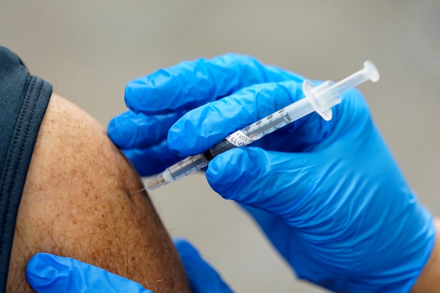 In this Jan. 5, 2021, file photo, healthcare worker receives a second Pfizer-BioNTech COVID-19 vaccine shot at Beaumont Health in Southfield, Mich. (AP Photo/Paul Sancya, File)