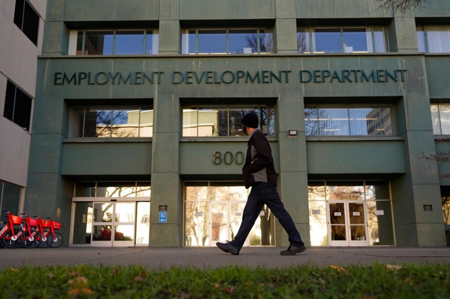 In this Dec. 18, 2020, file photo, a person passes the office of the California Employment Development Department in Sacramento, Calif. (AP Photo/Rich Pedroncelli, File)