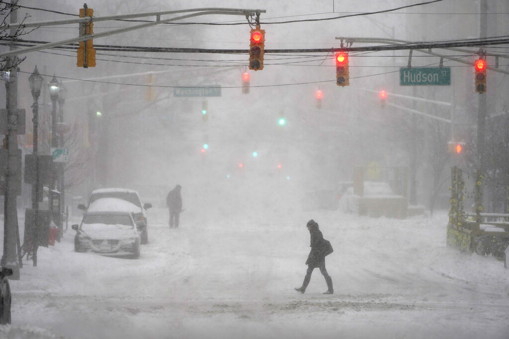 Pedestrians make their way through heavy snow and wind in Hoboken, N.J., Monday, Feb. 1, 2021. (AP Photo/Seth Wenig)