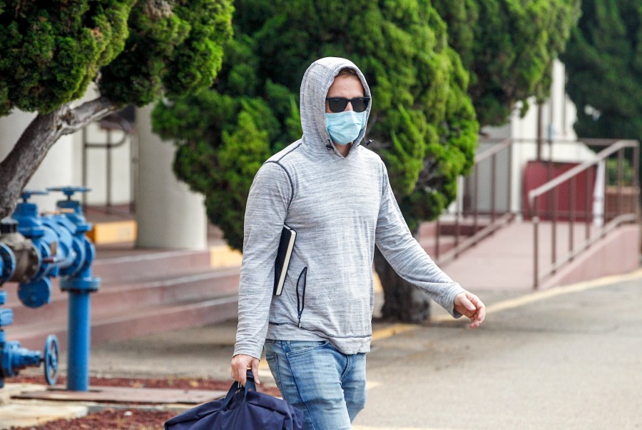 Petty Officer First Class Adel Enayat leaves the building after appearing for a hearing at Naval Base San Diego on Aug. 21, 2020, in San Diego. (Eduardo Contreras/The San Diego Union-Tribune via AP)