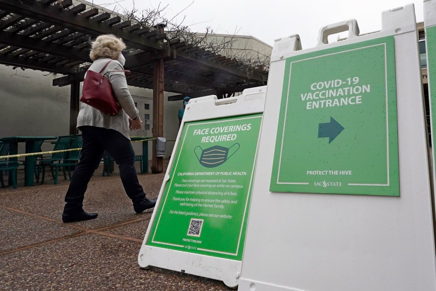 Signs direct people to a recently opened COVID-19 vaccination center at CSU Sacramento on Feb. 2, 2021. (Rich Pedroncelli / Associated Press)