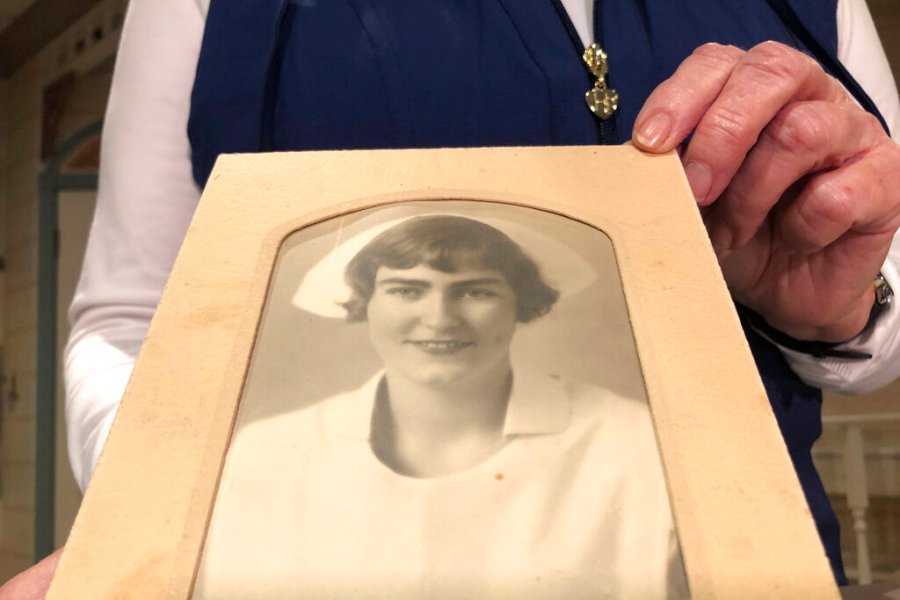 Nurse practitioner Sigrid Stokes, 76, holds a photograph of her mother at the Salinas Valley Memorial Hospital in Salinas, Calif., Wednesday, Feb. 3, 2021.  (AP Photo/Haven Daley)