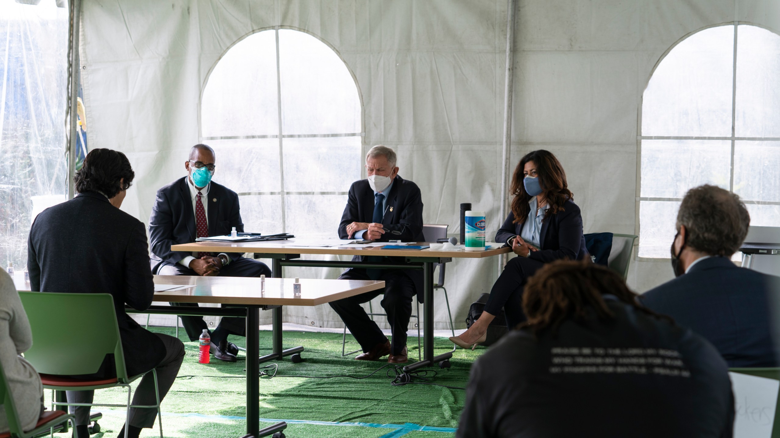 Los Angeles City Council member Kevin de Leon, far left, addresses U.S. District Judge Andre Birotte, second from left, U.S. District Court Judge David Carter, middle, and special master Michele Martinez, right, at a court hearing inside a tent at Downtown Women's Center in Los Angeles on Feb. 4, 2021. (AP Photo/Damian Dovarganes)