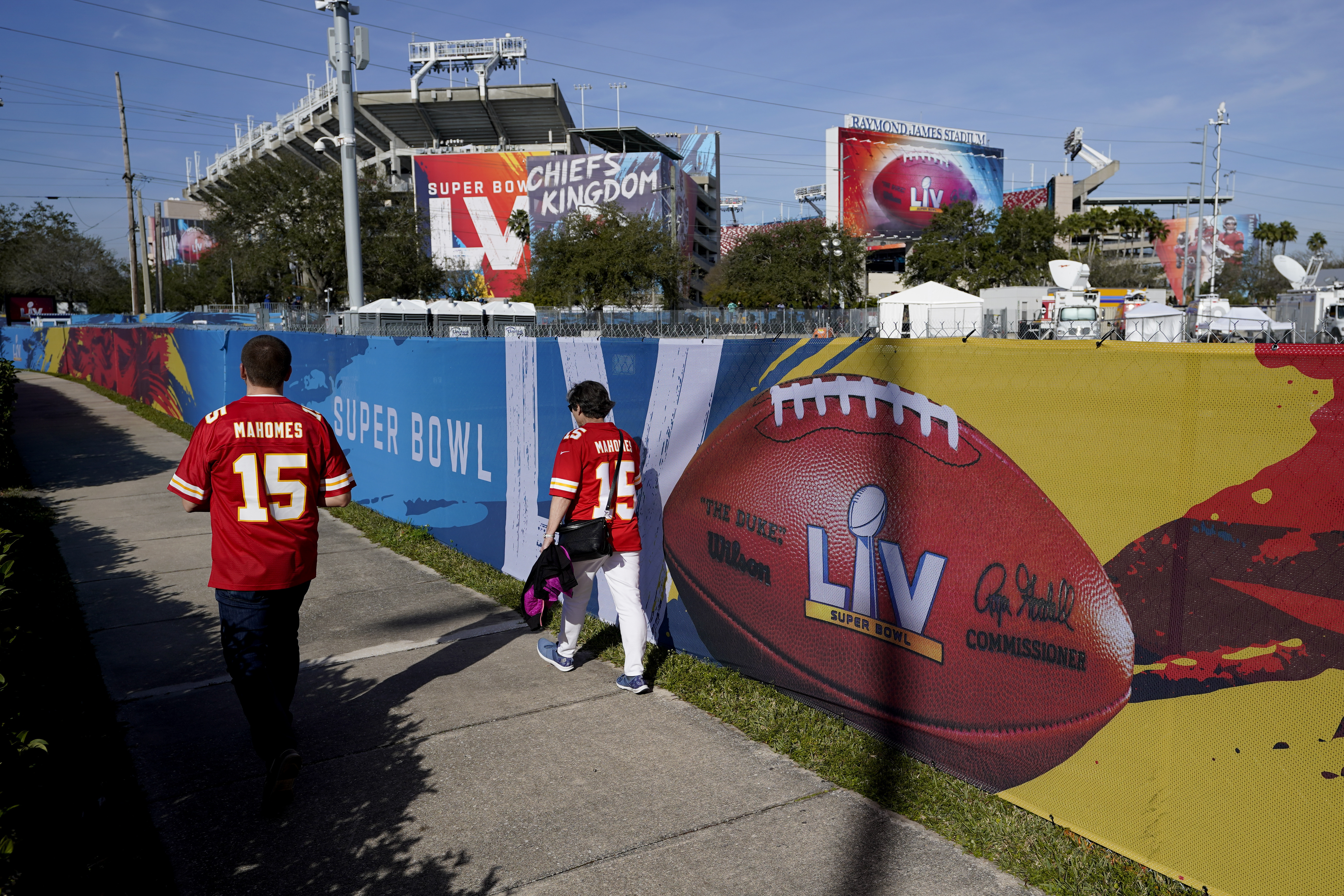 In this Feb. 4, 2021, file photo, Kansas City Chiefs fans walk past Raymond James Stadium ahead of Super Bowl 55 in Tampa, Fla. (AP Photo/Charlie Riedel, File)