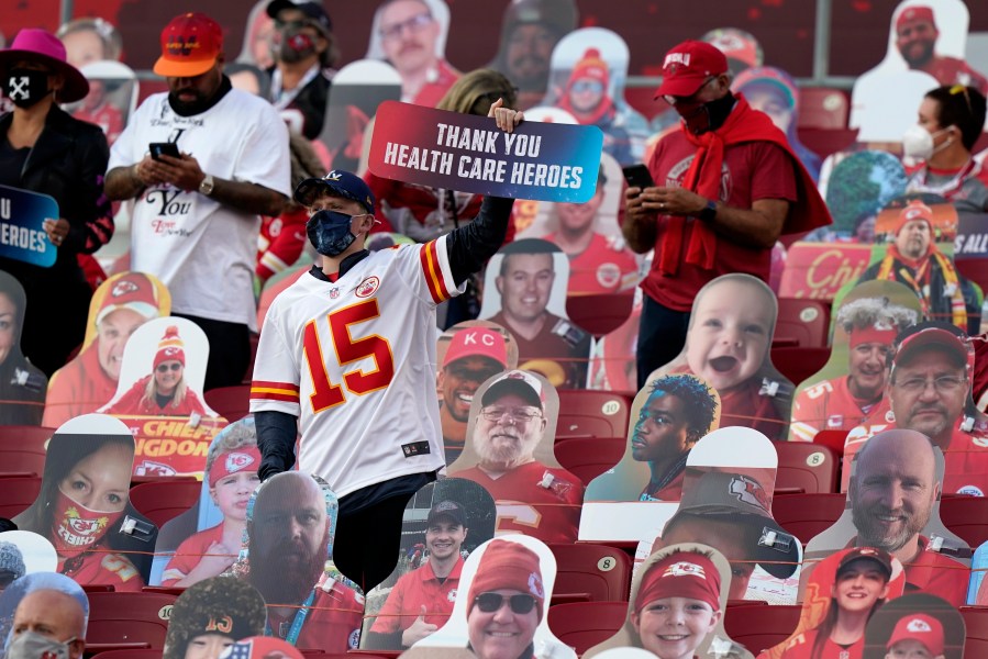 A fan holds up a sign honoring heart care workers before the NFL Super Bowl 55 football game between the Kansas City Chiefs and Tampa Bay Buccaneers, Sunday, Feb. 7, 2021, in Tampa, Fla. (AP Photo/Lynne Sladky)