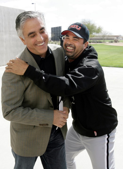 In this Saturday, Feb. 16, 2008, file photo, Chicago White Sox manager Ozzie Guillen, right, jokes with ESPN's Pedro Gomez after a news conference during the first day of baseball spring training for pitchers and catchers, in Tucson, Ariz. (AP Photo/M. Spencer Green, File)