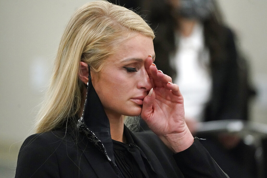 Paris Hilton wipes her eyes after speaking at a committee hearing at the Utah State Capitol, Monday, Feb. 8, 2021, in Salt Lake City. (AP Photo/Rick Bowmer)