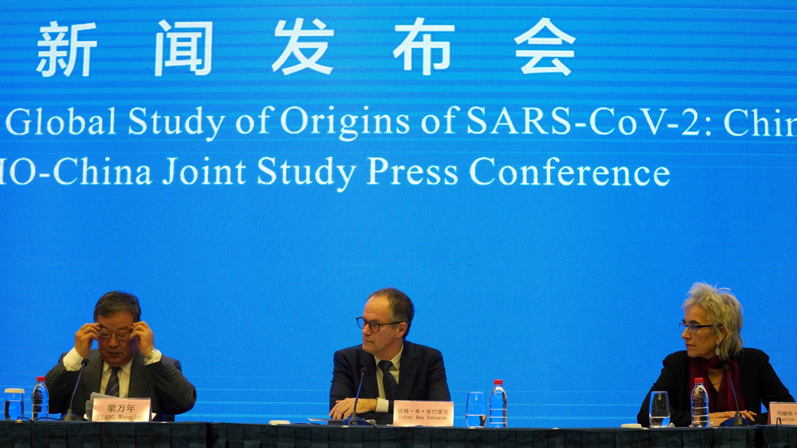 Marion Koopmans, right, and Peter Ben Embarek, center, of a World Health Organization team look over at their Chinese counterpart Liang Wannian, left, during a WHO-China Joint Study Press Conference held at the end of their mission to investigate the origins of the coronavirus pandemic in Wuhan in central China's Hubei province, Tuesday, Feb. 9, 2021. (AP Photo/Ng Han Guan)