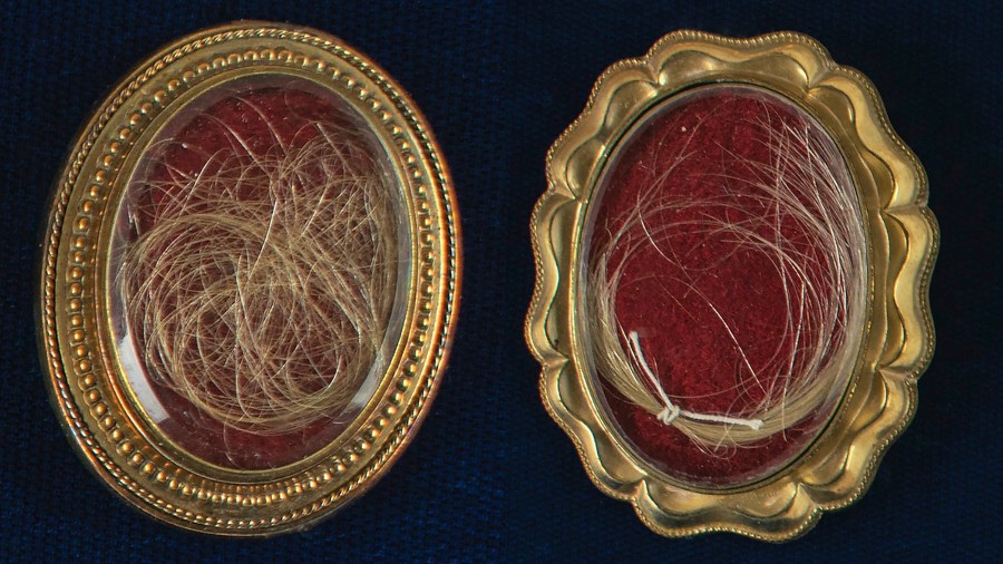 This undated photo released by RR Auction shows locks of hair from the heads of the first United States President George Washington, right, and from his wife Martha, left, up for auction between between Feb. 11-18, 2021, by the Boston-based auction firm. (Nikki Brickett/RR Auction via AP)