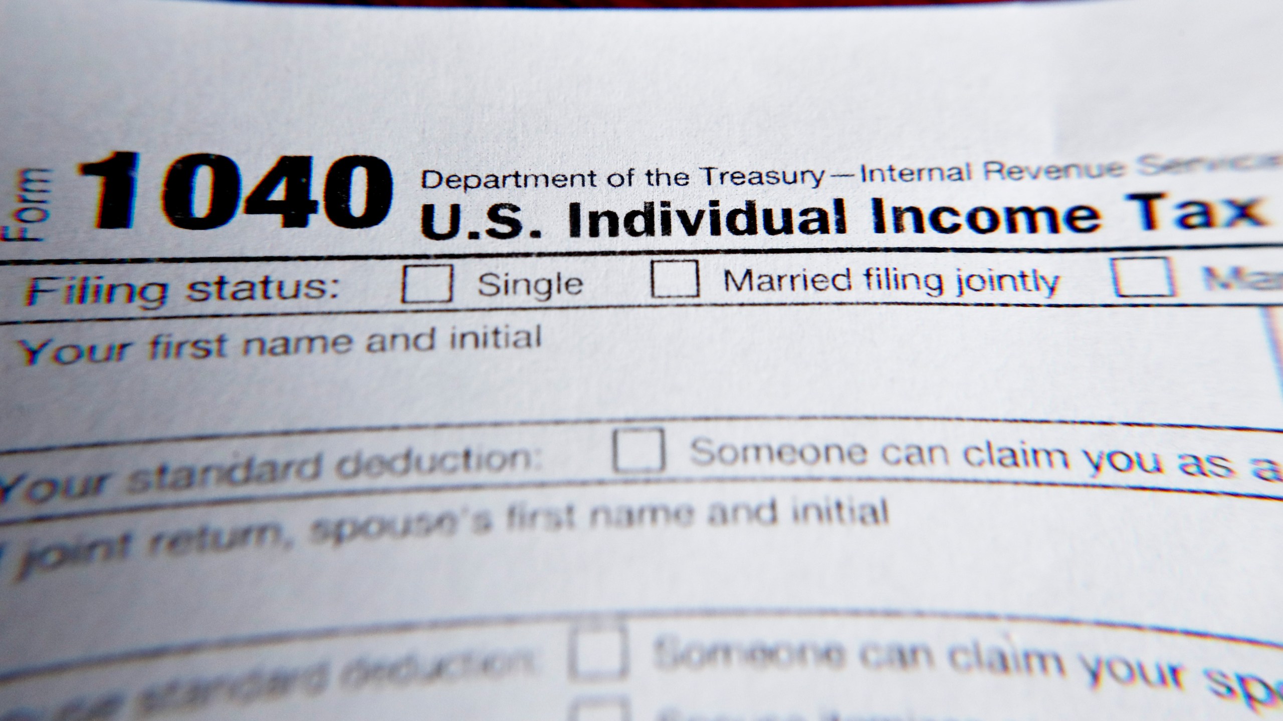 This Wednesday, Feb. 13, 2019 file photo shows part of a 1040 federal tax form printed from the Internal Revenue Service website, in Zelienople, Pa. Tax filing season will start a bit later and look a bit different this year. That’s because the pandemic that defined 2020 has seeped into tax time as well. If you worked from home, received a relief payment, took on some gig work or filed unemployment benefits _ or someone filed a fake claim in your name _ there are things you need to be aware of. Likewise if you normally receive certain tax credits. The IRS will begin accepting tax returns on Feb. 12, 2021. (AP Photo/Keith Srakocic, File)