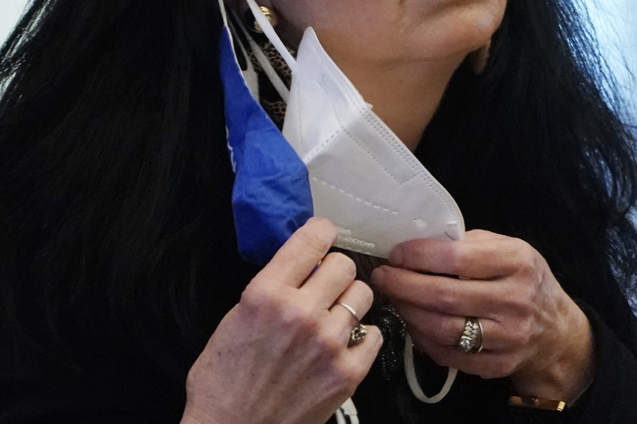 A state legislator adjusts her face masks while asking a question at the Capitol in Jackson, Miss., on Feb. 4, 2021. (Rogelio V. Solis / Associated Press)