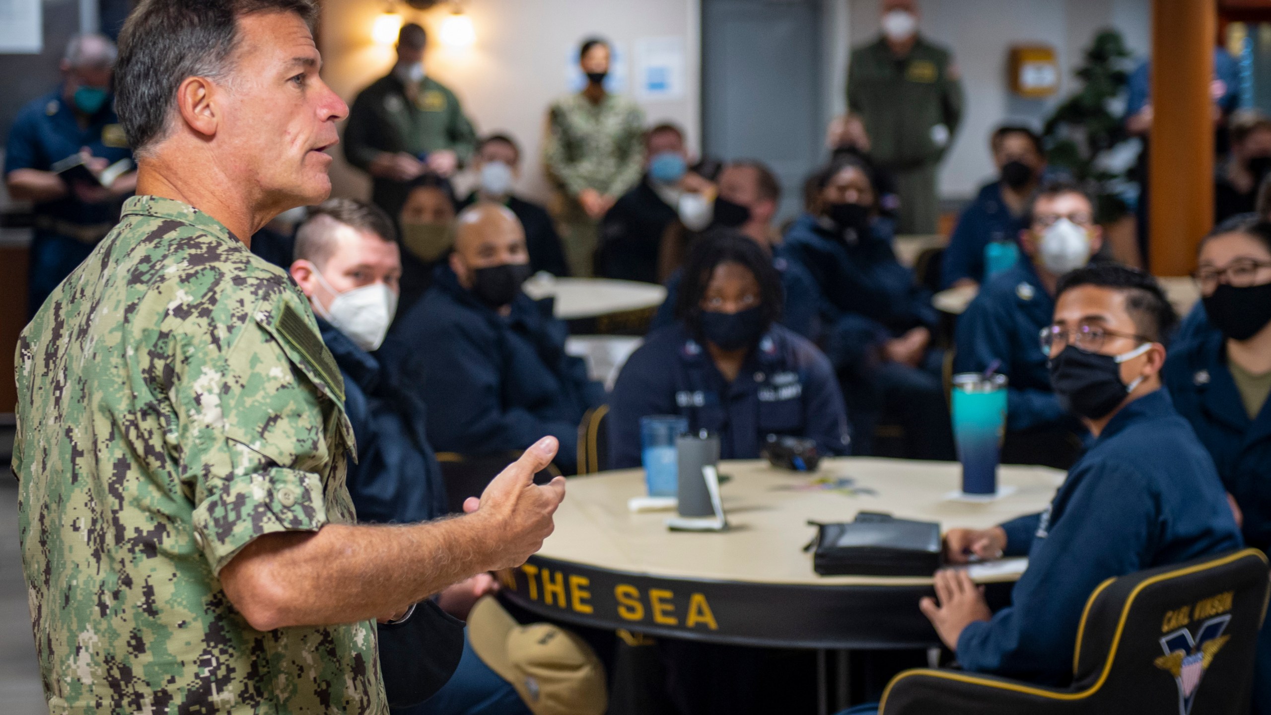 In this Feb. 8, 2021, photo provided by the U.S. Navy, Adm. John Aquilino, commander, U.S. Pacific Fleet, speaks with sailors assigned to the USS Carl Vinson after recent racist incidents. (Mass Communication Spc. Seaman Apprentice Mason Congleton / U.S. Navy via Associated Press)