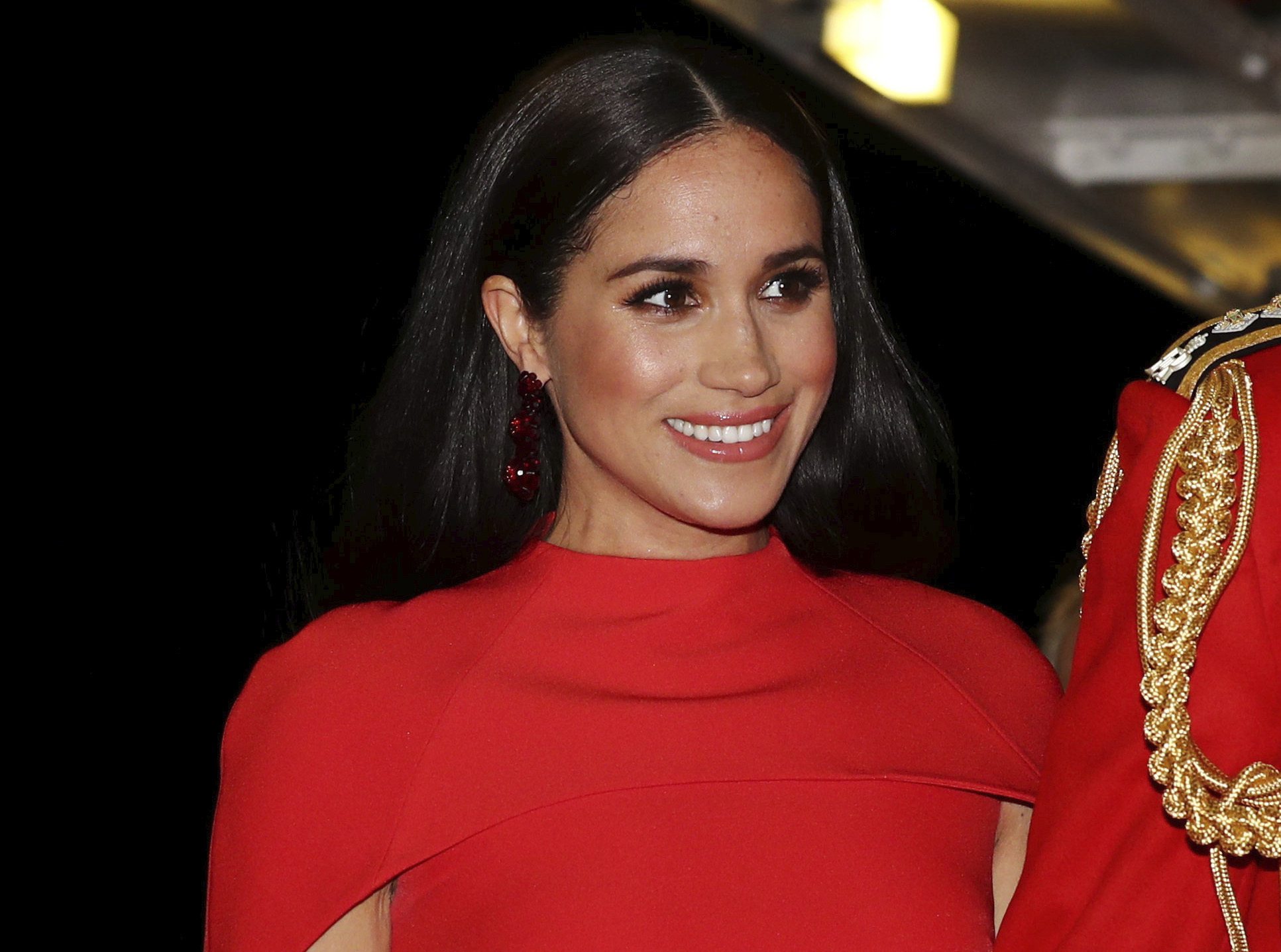 In this Saturday March 7, 2020 file photo, Meghan, Duchess of Sussex with Prince Harry arrives at the Royal Albert Hall in London, to attend the Mountbatten Festival of Music. (Simon Dawson/Pool via AP, File)