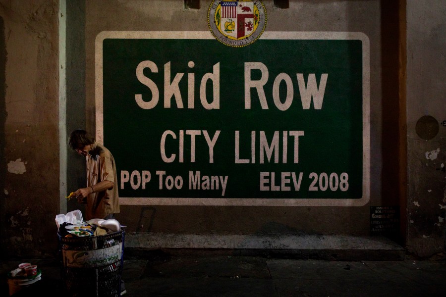 A homeless man takes food from a trash can in Los Angeles' Skid Row area, home to the nation's largest concentration of homeless people in Los Angeles, on Oct. 28, 2017. (Jae C. Hong / Associated Press)