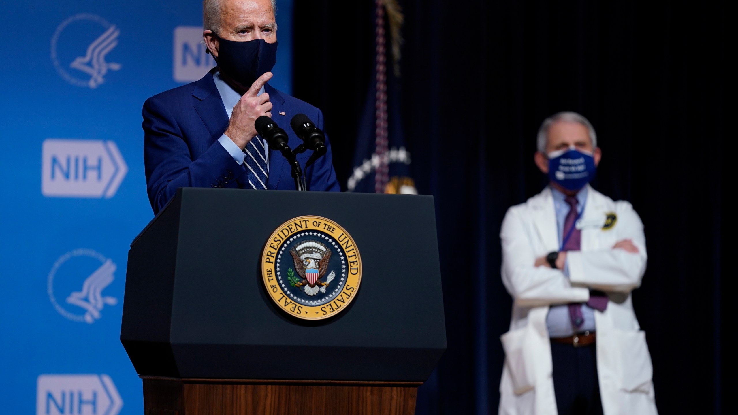 President Joe Biden speaks during a visit to the Viral Pathogenesis Laboratory at the National Institutes of Health in Bethesda, Md. on Feb. 11, 2021 as Dr. Anthony Fauci looks on. (Evan Vucci/Associated Press)