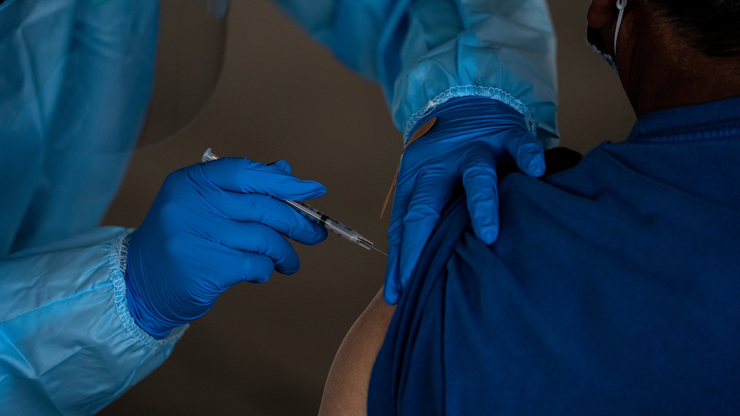 In this Jan. 21, 2021, file photo, a person receives the Pfizer-BioNTech COVID-19 vaccine in Mecca, Calif. (AP Photo/Jae C. Hong, File)