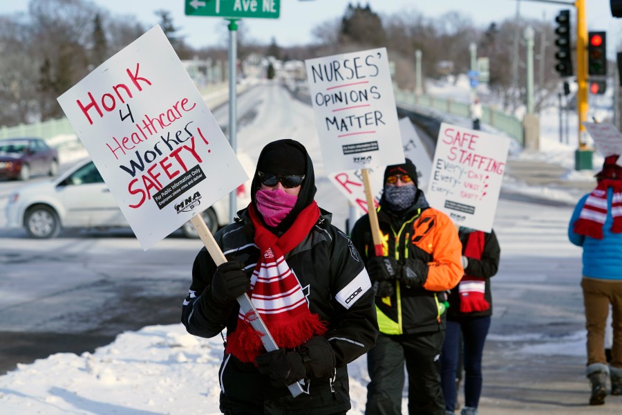 Nurses picket Friday, Feb. 12, 2021 in Faribault, Minn., during a healthcare worker protest of a shortage on protective masks. (AP Photo/Jim Mone)