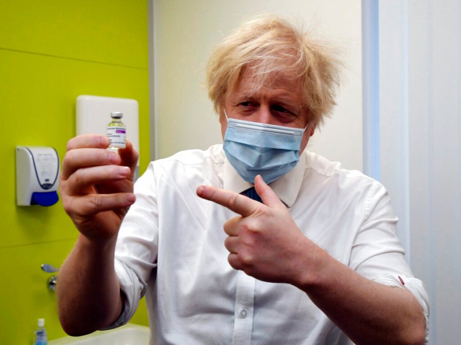 Britain's Prime Minister Boris Johnson holds a vial of the AstraZeneca vaccine during a visit to a coronavirus vaccination centre at the Health and Well-being Centre in Orpington, south-east London, Monday, Feb. 15, 2021. (Jeremy Selwyn/Pool Photo via AP)