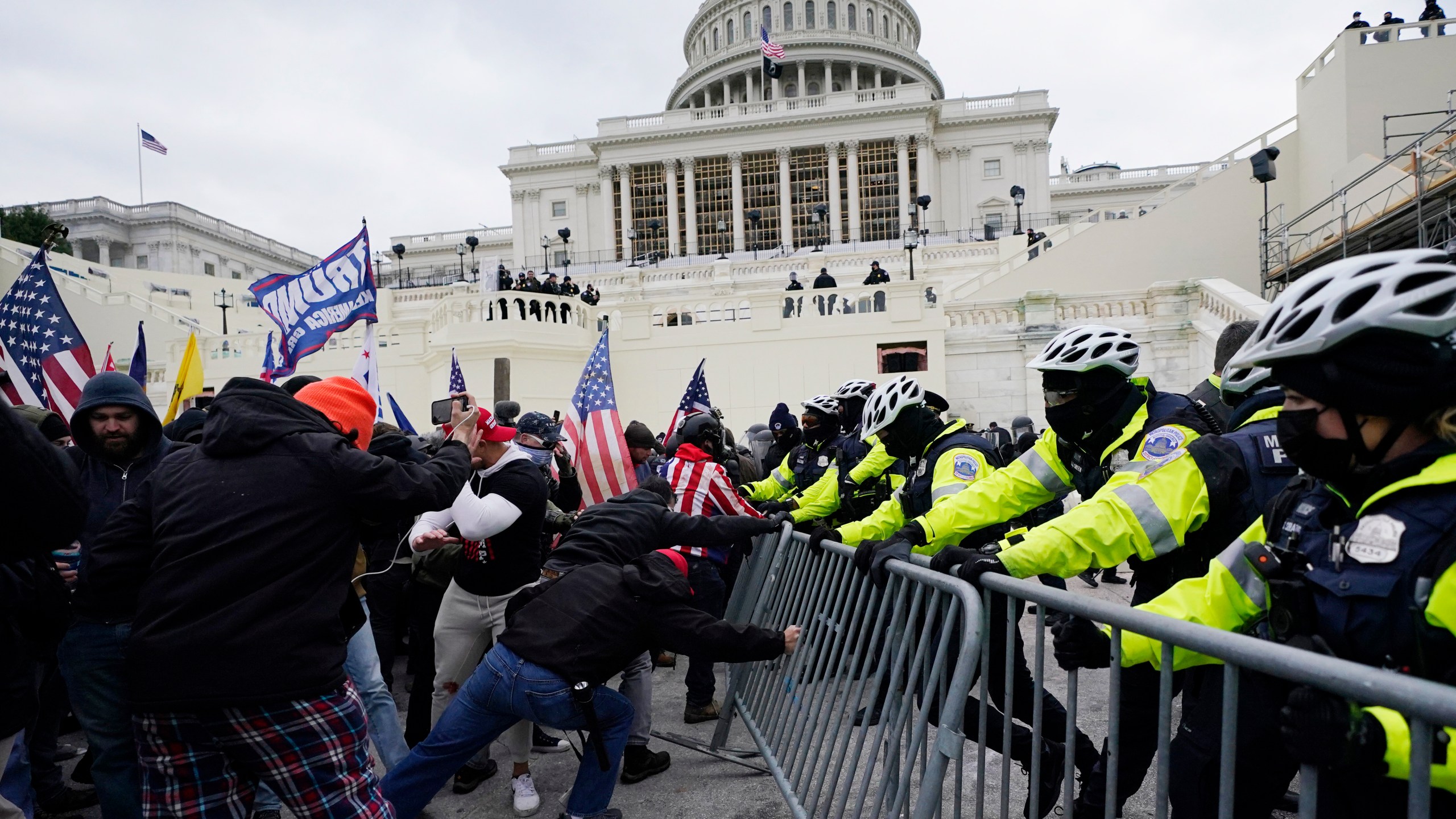 In this Jan. 6, 2021 file photo, rioters try to break through a police barrier at the Capitol in Washington. (AP Photo/Julio Cortez, File)