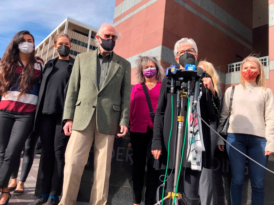 Kathleen McIlvain, center, speaks outside federal court in Los Angeles on Feb. 16, 2021, after the court appearance of Jerry Boylan, a scuba dive boat captain who is charged with 34 counts of seaman's manslaughter. McIlvain's son, Charles McIlvain, was among 34 people killed during a 2019 fire aboard Boylan's boat. (Stefanie Dazio / Associated Press)