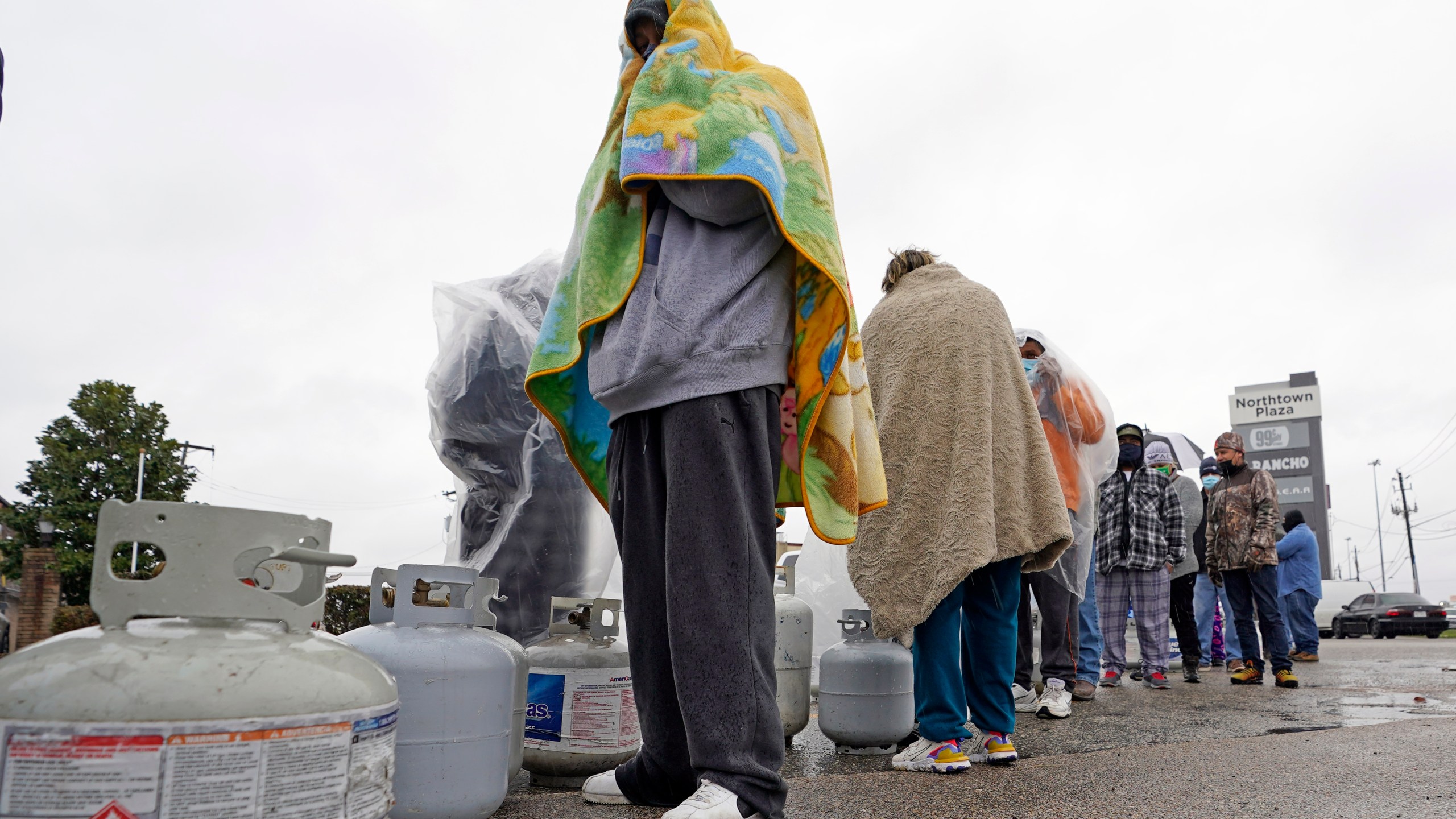 Carlos Mandez waits in line to fill his propane tanks Wednesday, Feb. 17, 2021, in Houston. (AP Photo/David J. Phillip)