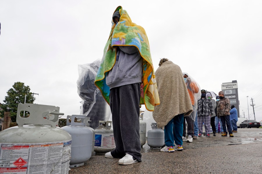 Carlos Mandez waits in line to fill his propane tanks Wednesday, Feb. 17, 2021, in Houston. (AP Photo/David J. Phillip)