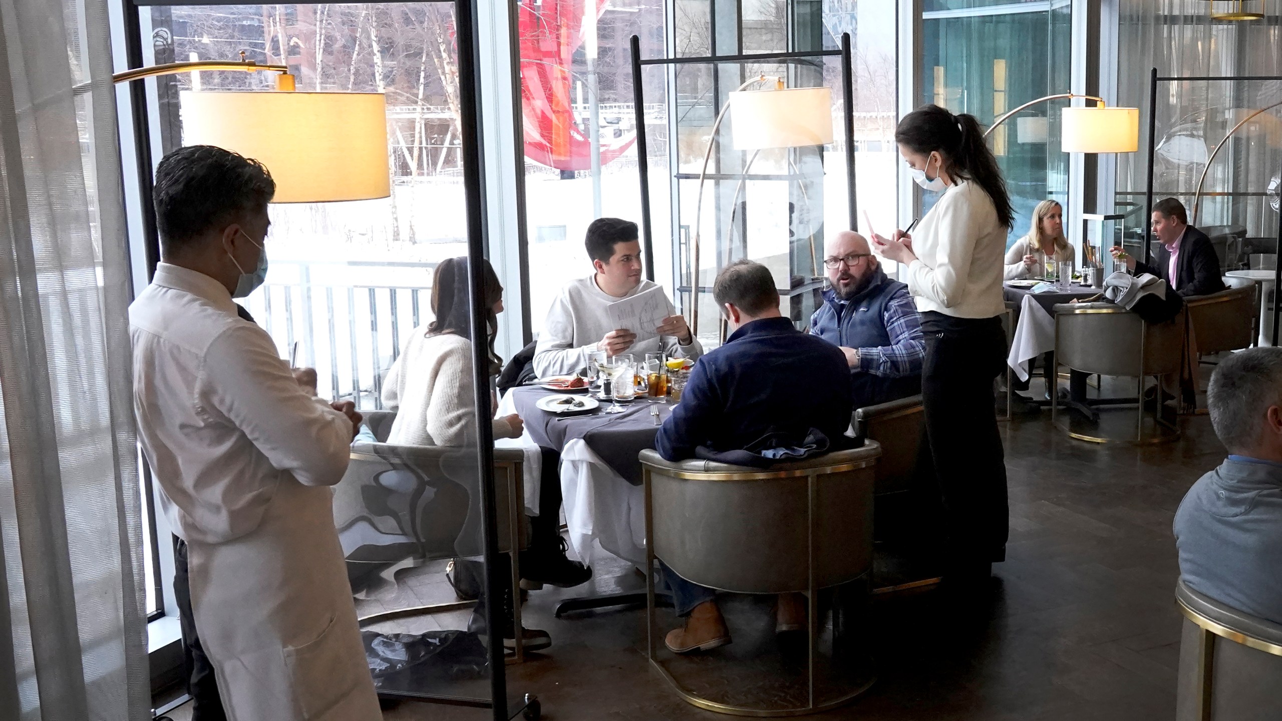 In this Jan. 27, 2021, file photo, patrons enjoy lunch indoors at Gibsons Italia restaurant in Chicago. States are beginning to ease coronavirus restrictions, but health experts say we don’t know enough yet about variants to roll back measures that could help slow their spread. (AP Photo/Charles Rex Arbogast, File)