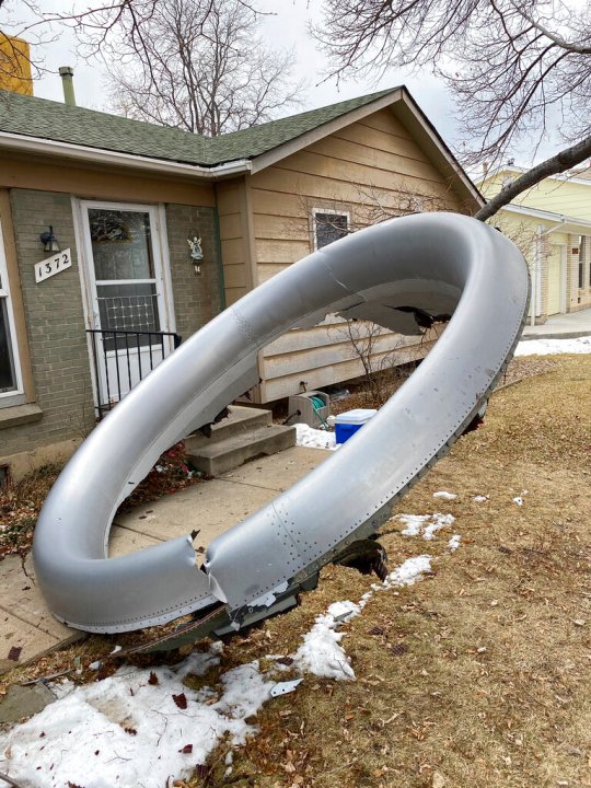 In this photo provided by the Broomfield Police Department on Twitter, debris is scattered in the front yard of a house at near 13th and Elmwood, Saturday, Feb. 20, 2021, in Broomfield, Colo. (Broomfield Police Department via AP)