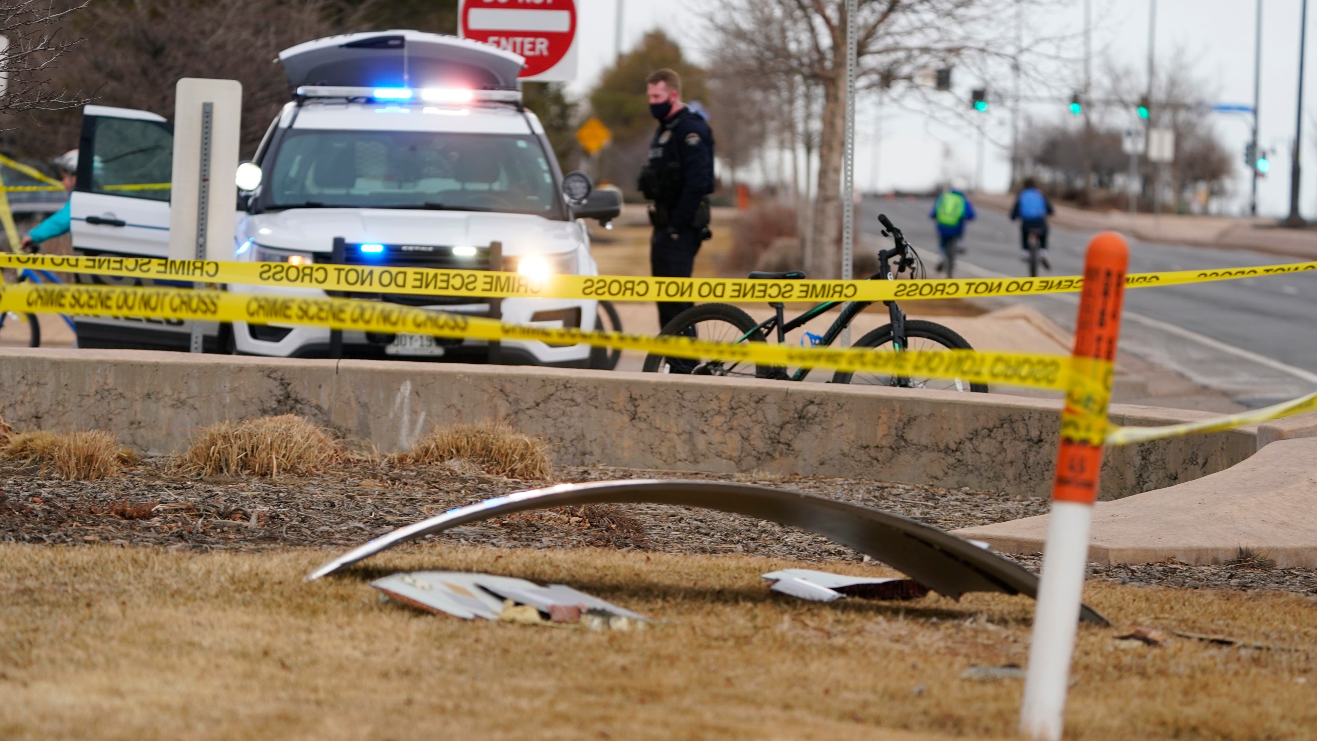 A piece of debris from a commercial airplane is marked off by police tape where it landed along Midway Boulevard in Broomfield, Colo., as the plane shed parts while making an emergency landing at nearby Denver International Airport Saturday, Feb. 20, 2021. (AP Photo/David Zalubowski)