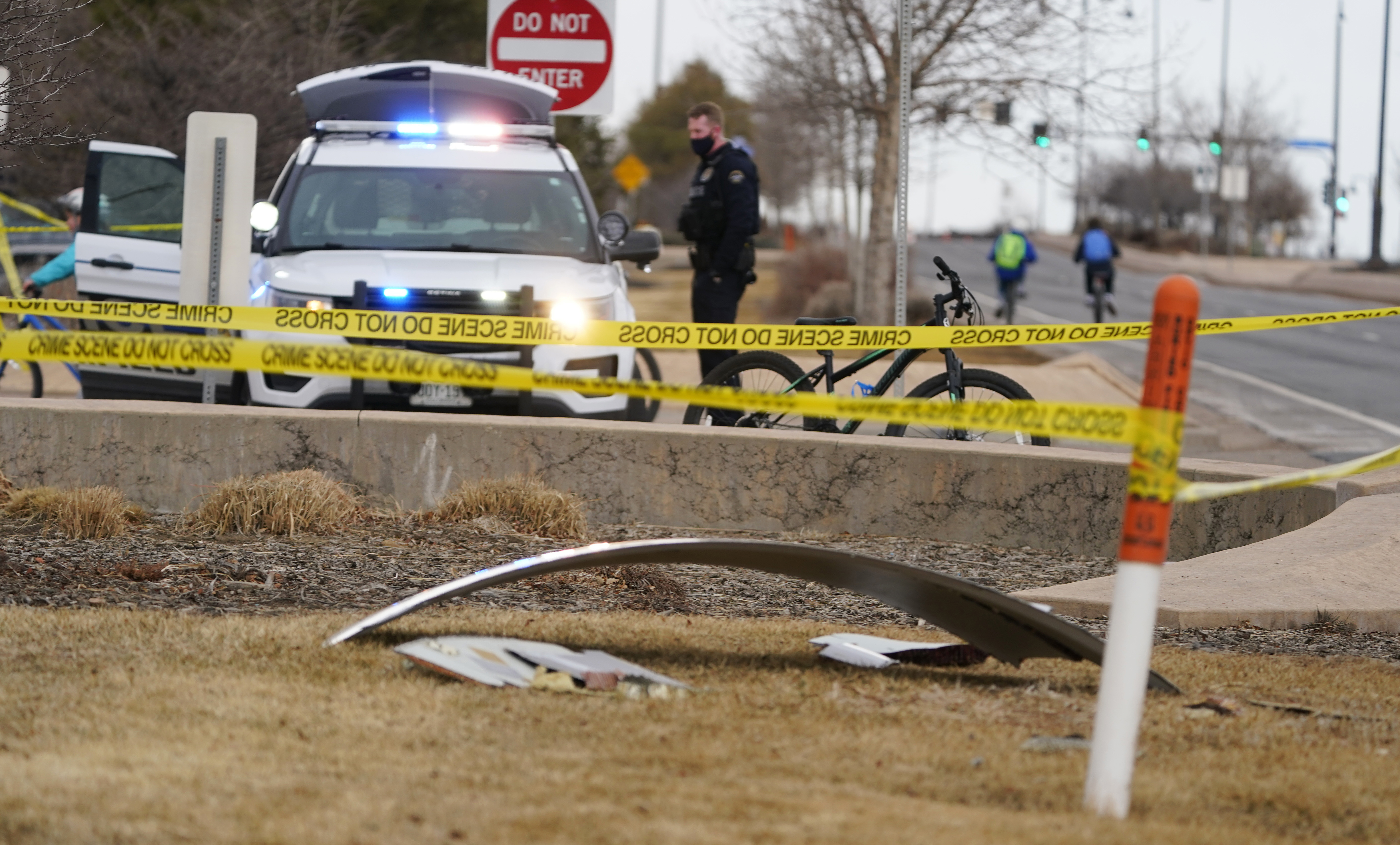 A piece of debris from a commercial airplane is marked off by police tape where it landed along Midway Boulevard in Broomfield, Colo., as the plane shed parts while making an emergency landing at nearby Denver International Airport Saturday, Feb. 20, 2021. (AP Photo/David Zalubowski)