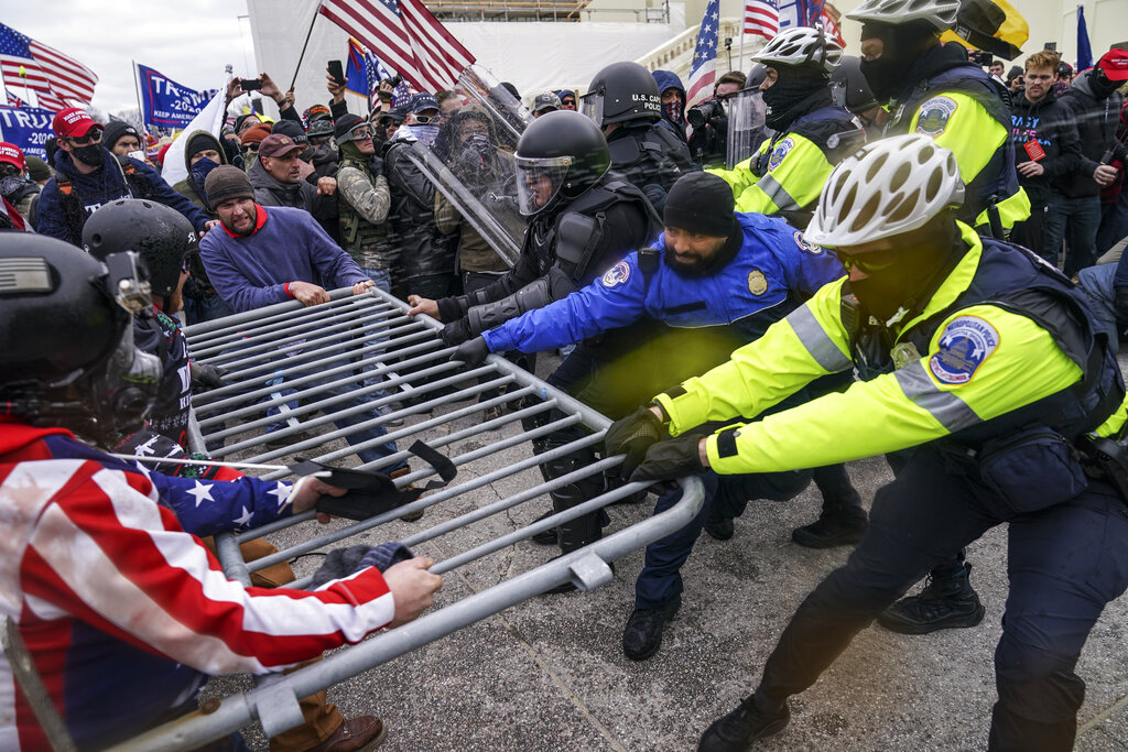 In this Jan. 6, 2021, file photo rioters try to break through a police barrier at the Capitol in Washington. (AP Photo/John Minchillo, File)