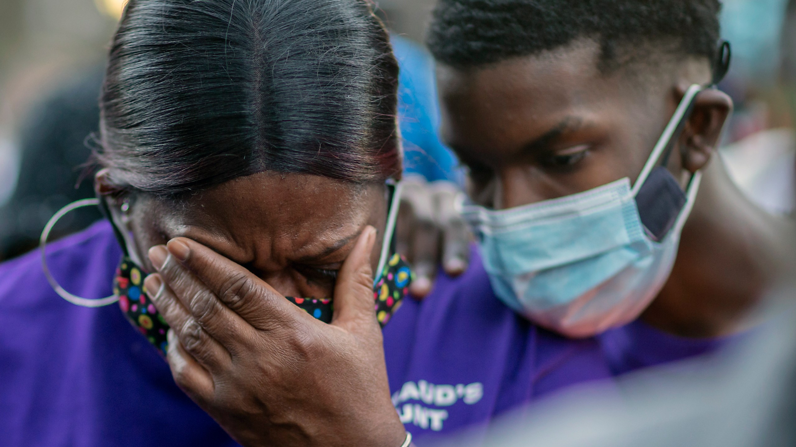 Evon Arbery, Ahmaud Arbery's aunt, left, is comforted by family during a memorial walk and candlelight vigil for her nephew in Brunswick, Ga., on Feb. 23, 2021. (Stephen B. Morton / Associated Press)